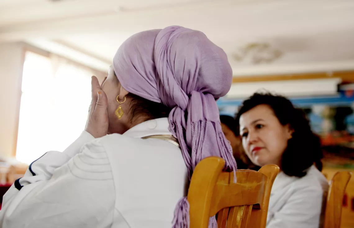 Biya, a mother of three girls, breaks into tears during a peer education session while explaining her decision to abort her second pregnancy at five months because her first daughter, diagnosed with AIDS, was sick.