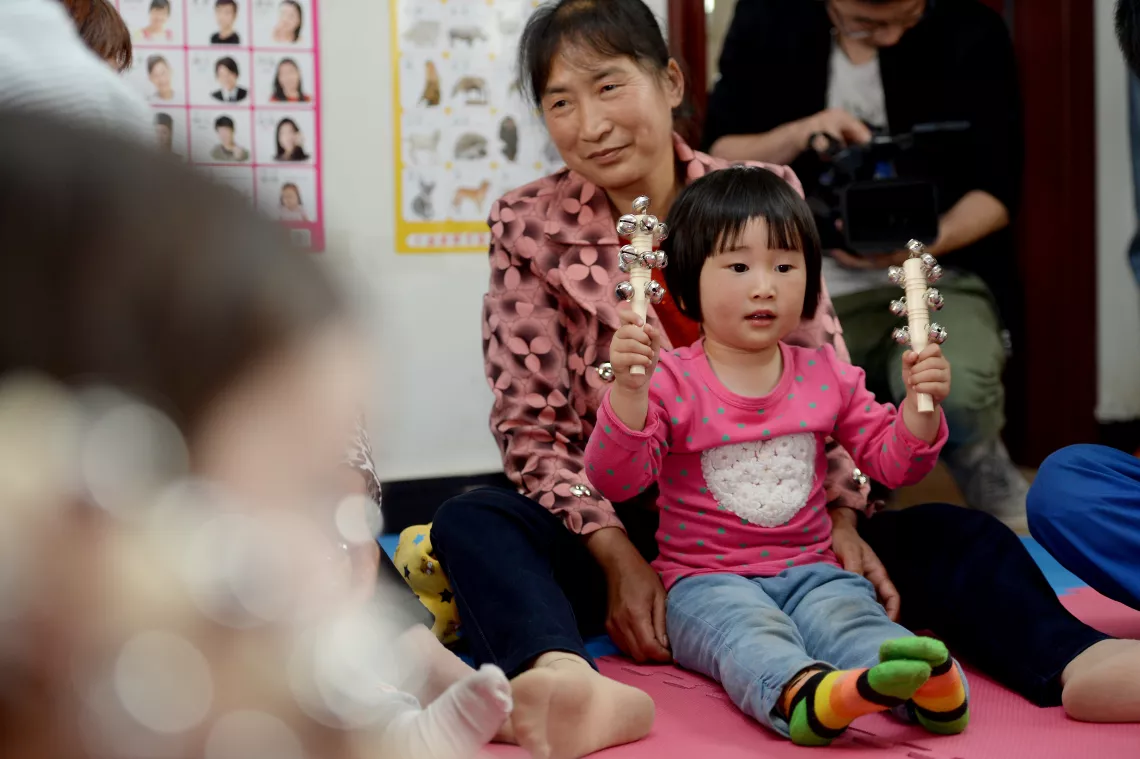 Like many children in Ai village, on the outskirts of Yichang city in Hubei Province, 3-year-old Yangyang was left behind by parents who migrated to a coastal city for better-paying jobs.