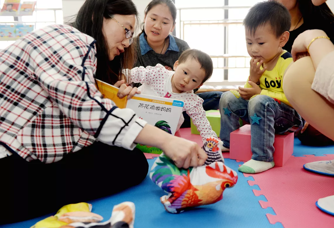 Volunteers at the community ECD centres help caregivers move from rote learning to more creative ways to engage and stimulate children through games and storytelling.