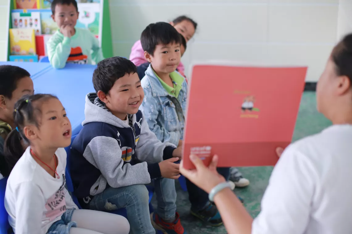 Liu Fen tells a story to kids at the Yelang Village Kindergarten.