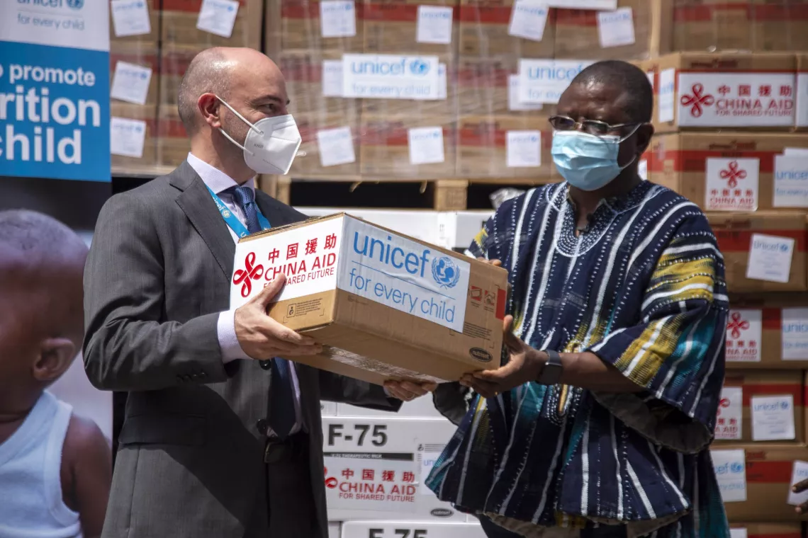 UNICEF Deputy Representative Fiachra McAsey hands over a consignment of nutrition supplements to Dr. Kofi Issah, Director of the Family Health Division of the Ghana Health Service in Accra, on 26 February 2021. The supplements are part of the support provided by China International Development Cooperation Agency (CIDCA) to the Government of Ghana to reduce malnutrition during the COVID-19 pandemic.