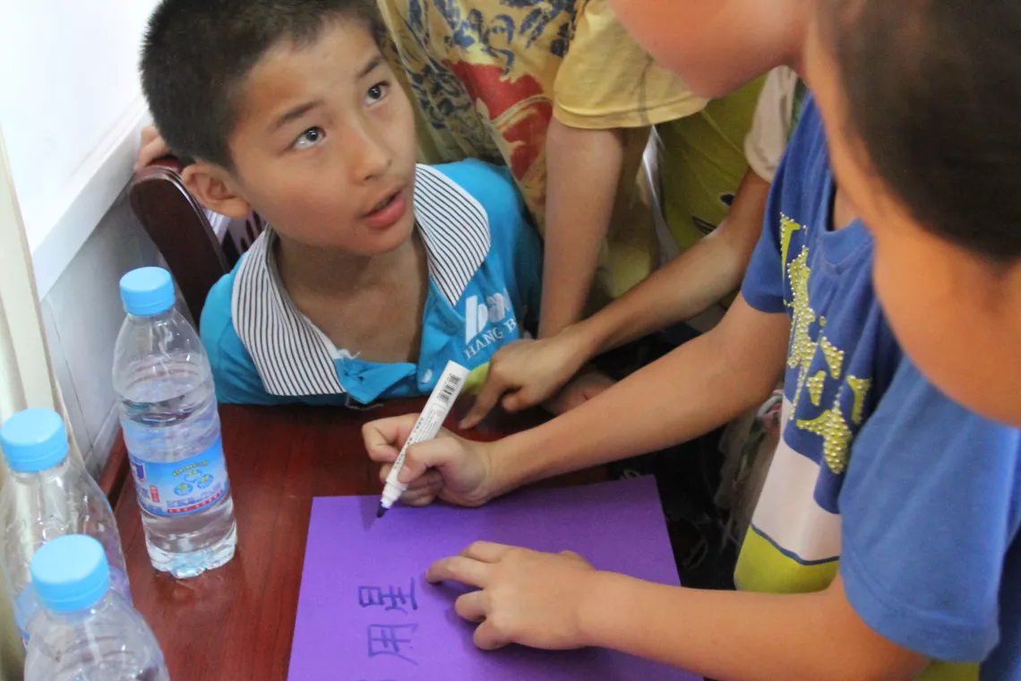 Children in Ganjing primary school in Zhong County, after the participatory hygiene education class, each group will develop a slogan to show what they have learnt, and what they will do next.