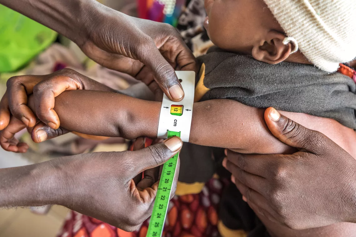 A health worker checks Labadan Adamu's upper arm measurement. Adams recovered from severe acute malnutrition after undergoing the EU-UNICEF supported treatment programme at the Primary Health Care Center in Binkola, Adamawa, Nigeria.