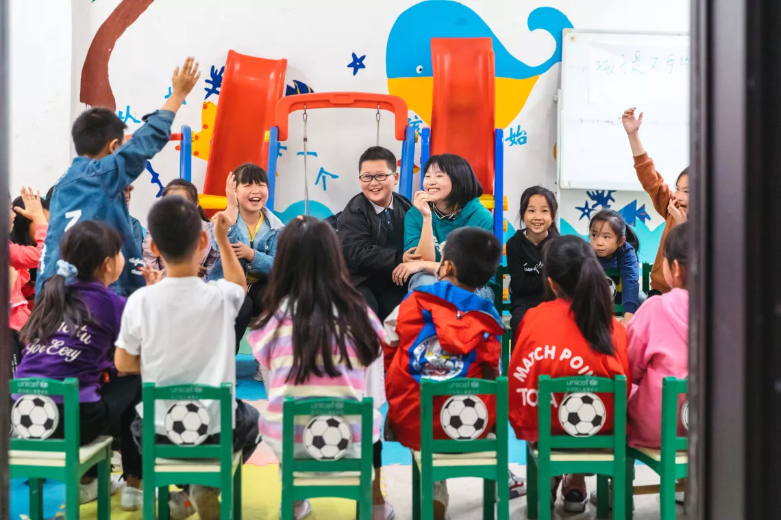 Lamei, 22, shares her experience with children at the child-friendly space of Qianfo Town, Sichuan Province.