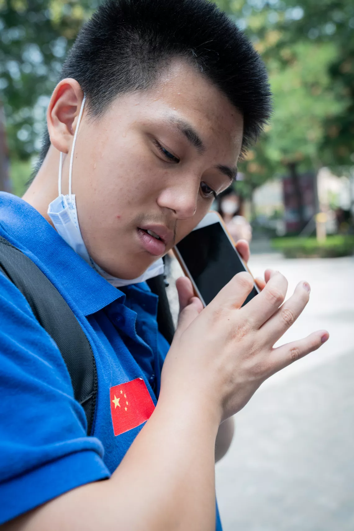 Zhao Chen uses the accessibility feature on his cell phone to read what's on the screen in Beijing, China, on 20 July, 2020.