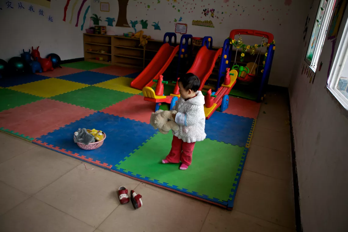A little girl is playing in the Child Friendly Space (CFS) in Hengxi, Sichuan Province.