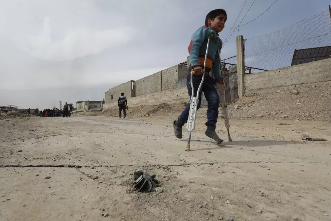 On 15 March 2018 in Beit Sawa, eastern Ghouta. a boy on crutches walks towards Hamourieh where an evacuation exit from eastern Ghouta has been opened.