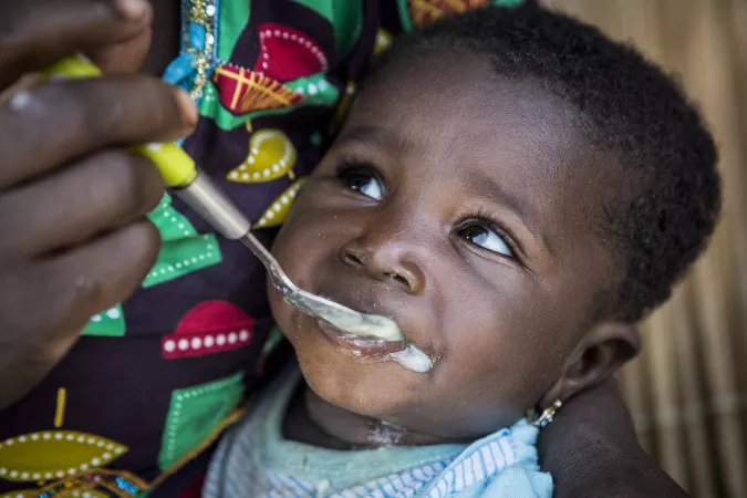 Chatou Dembele, 6 months old, eats porridge enriched with micronutrient powder in Mali.