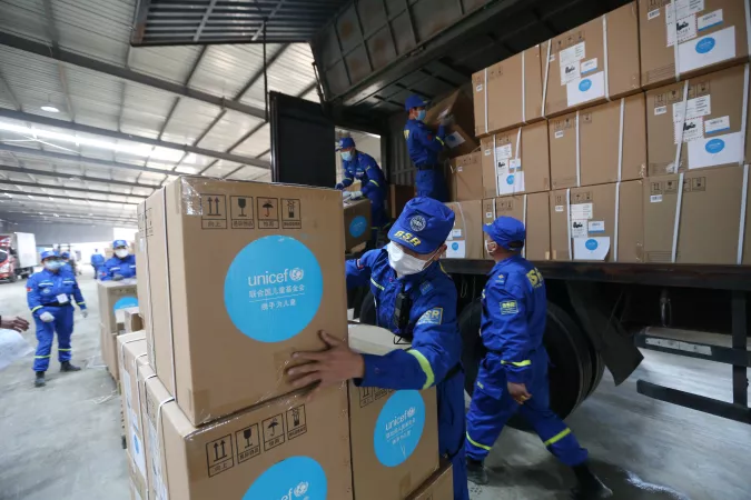Volunteers load off ROK-funded hospital equipment in an emergency warehouse of the Hubei Charity Foundation in Wuhan, the epicenter of the COVID-19 outbreak, on 18 March 2020. 
