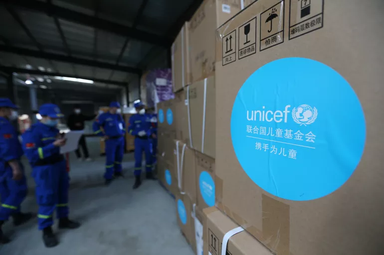 Volunteers check and accept UNICEF donated supplies in an emergency warehouse of the Hubei Charity Foundation in Wuhan, the epicenter of the COVID-19 outbreak, on 18 March 2020.