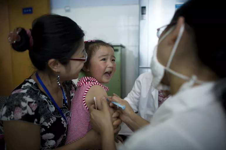 A girl cries while being vaccinated at Sichuan University in Chengdu, the provincial capital.