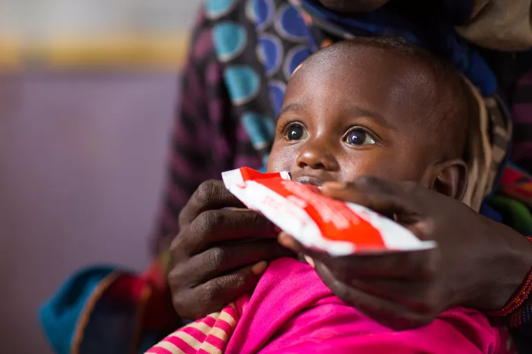 2-year-old Gemechu Teteche feeds on therapeutic food in Ethiopia.