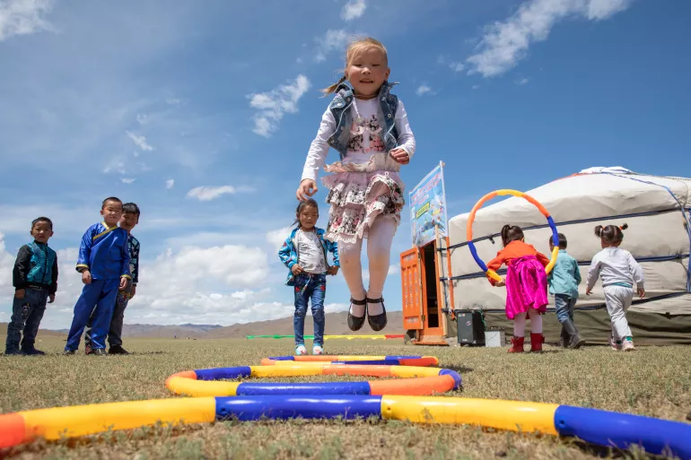 Children play outdoors at the newly opened mobile ‘ger’ (traditional nomadic tent) kindergarten in the Janjin bagh area, in Erdenetsogt soum in Bayankhongor Province, Mongolia, on 17 June 2018. 