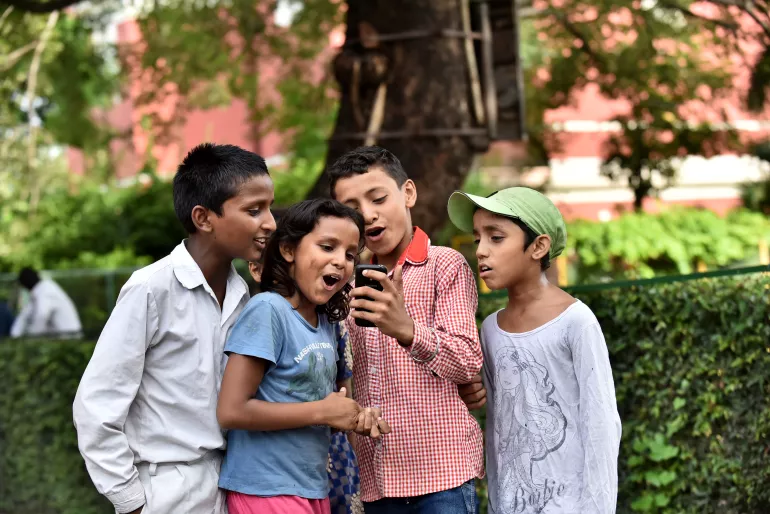2016年8月31日，在Delhi的St. Columba’s 学校，来自贫民区的孩子使用移动电话。