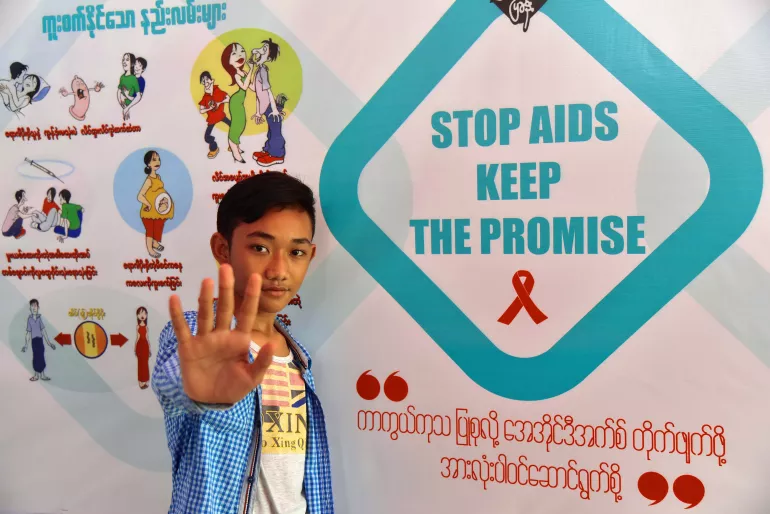 The three excited 16-year-old friends, Kyaw Nay Soe, Zayar Win and Phyo Min Tun, comes to check out the HIV/AIDS awareness-raising and health tips display booth set up by the National AIDS Program (Mandalay Region) with the support of UNICEF and partners at the famous Taung Pyone Festival in 2016.