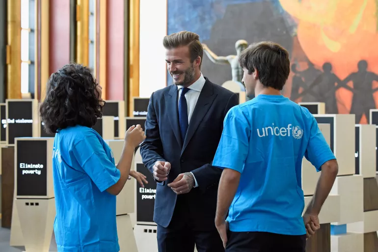 On 24 September 2015, (foreground, left-right) Noor Samee, 16, and Rodrigo Bustamante, 17, chat with UNICEF Goodwill Ambassador David Beckham in front of the unique new digital installation ‘Assembly of Youth’, at United Nations Headquarters (UNHQ). 