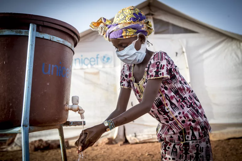 Hamsatou Bolly, 13, washes her hands at the Socoura displacement camp in Mopti.