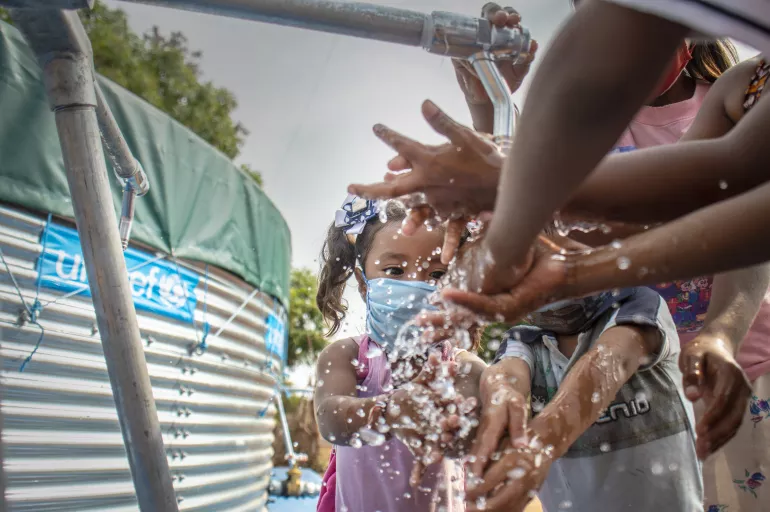  Children learn handwashing technique during the installation of a drinking water tank that will benefit 350 families at the Sierra Nevada Community, in the Zulia state, on April 23, 2020.