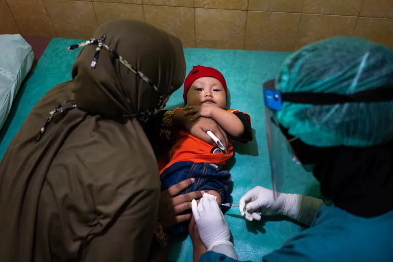 On 16 June 2020, a child is vaccinated at the Tegalrejo Community Health Centre in Yogyakarta, Indonesia.