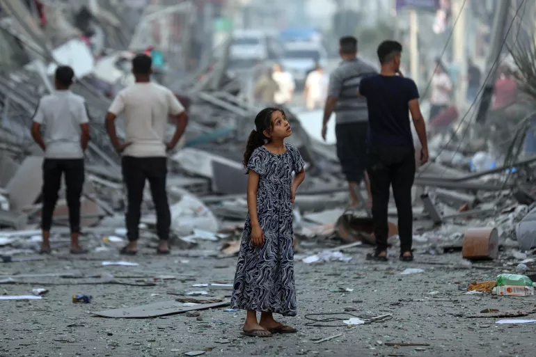 Amal, 7 years old, contemplates her neighbourhood after neighbouring homes were levelled to the ground. No words can describe the devastation she sees.